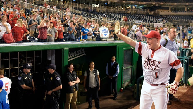 Louisiana Republican Rep. Steve Scalise celebrates with fans after the annual congressional baseball game at Nationals Park on June 23, 2016.