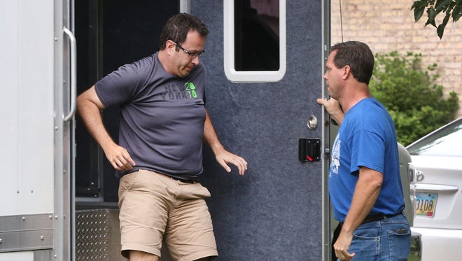 Subway spokesperson Jared Fogle exits an evidence truck parked in the driveway of his Zionsville home in the 4500 block of Woods Edge Drive in the Austin Oaks subdivision on Tuesday morning, July 7, 2015. Fogle was in the truck with FBI agents and Indiana State Police investigators as they searched computer devices and media storage disks while conducting a criminal investigation. FBI agents carried multiple items from the home to the truck for inspection. FogleÕs attorney says Fogle is cooperating in the probe and has not been detained or arrested. Russell Taylor, 43, who had been the Jared Foundation executive director, faces federal charges after being arrested in late April on seven counts of production of child pornography and one count of possession of child pornography.