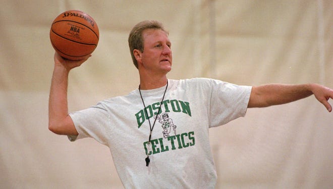 Boston Celtics legend Larry Bird inbounds the ball during the Celtics' practice at Brandeis University in Waltham, Mass., Nov. 19, 1996.