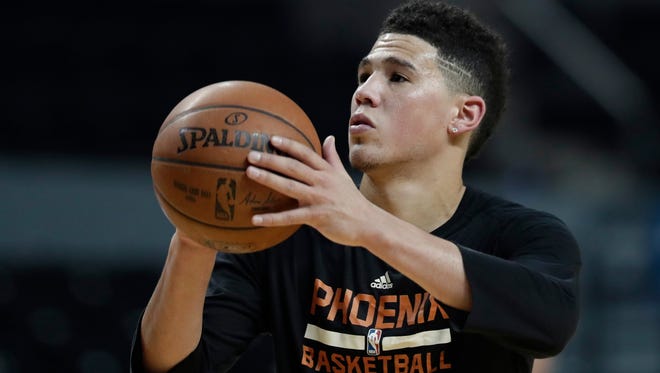 Phoenix Suns' Devin Booker shoot baskets during practice the day before a game against the Dallas Mavericks at Mexico City Arena on Wednesday, Jan. 11, 2017.
