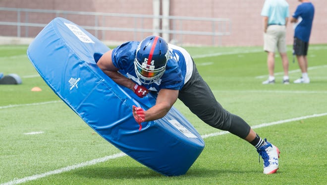 Giants defensive end Olivier Vernon goes through tackling drills during practice in East Rutherford, N.J.