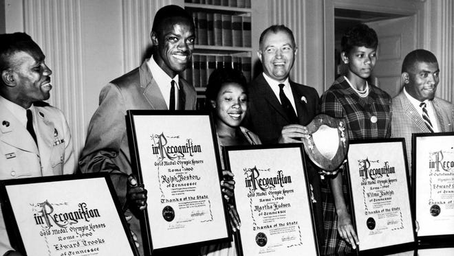 Tennessee's Olympic gold medal winners have been presented with scrolls by Gov. Buford Ellington expressing the thanks of the state for their achievement Oct. 3, 1960. Honored are Sgt. 1C Edward Crook of Ft. Campbell, left, Ralph Boston, Martha Hudson, the governor, Wilma Rudolph, and Coach Ed Temple.