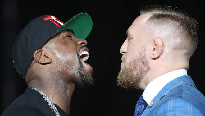 Floyd Mayweather and Conor McGregor stare each other down during a world tour press conference to promote the upcoming Mayweather vs McGregor boxing match.