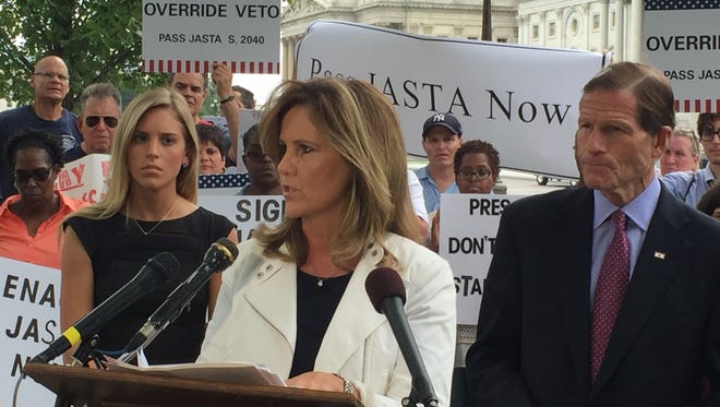 Terry Strada, national chairwoman of 9/11 Families and Survivors United for Justice Against Terrorism, speaks outside the U.S. Capitol on Sept. 20, 2016, urging President Obama to sign the Justice Against Sponsors of Terrorism Act.She is flanked by her daughter, Kaitlyn Strada, and Sen. Richard Blumenthal, D-Conn.