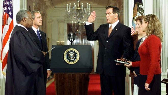 President George W. Bush watches as Tom Ridge is sworn in to head the new Office of Homeland Security by Thomas during an East Room ceremony at the White House on Oct. 8, 2001.