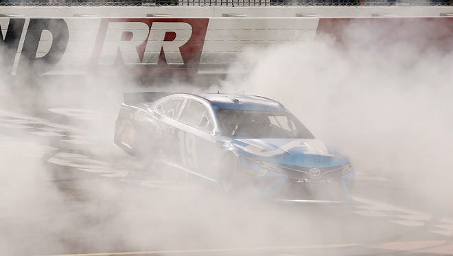 Martin Truex Jr. performs a burnout at Richmond Raceway after scoring his first win of the 2019 season and his first with Joe Gibbs Racing.