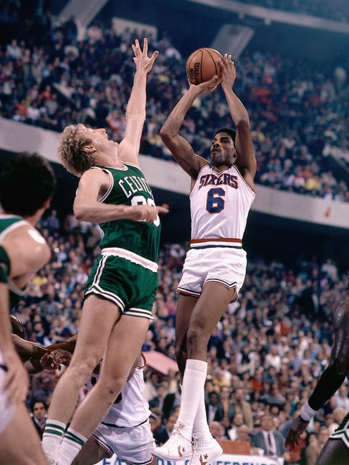 Julius Erving #6 of the Philadelphia 76ers shoots a jump shot against the Larry Bird # 33 of the Boston Celtics during an NBA game in 1982 at the Spectrum in Philadelphia, Pennsylvania.