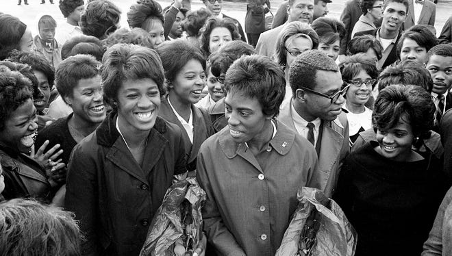 Tigerbelles stars Edith McGuire, left, and Wyomia Tyus shares the moment with their track teammates and fellow Tennessee A&I State students after arriving from Tokyo Olympics at Nashville Municipal Airport Oct. 28, 1964.