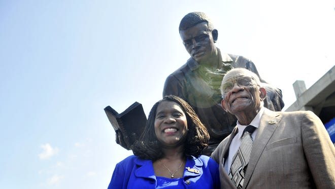 TSU President Glenda Glover, left, stands with legendary TSU track coach Ed Temple during the unveiling of his statue Aug. 28, 2015, honoring his 44-year career as the women's track coach at Tennessee State.