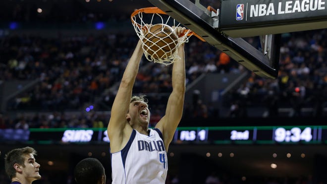 Dallas Mavericks Dirk Nowitzki scores against the Phoenix Suns in the first half of a regular-season NBA basketball game in Mexico City, Thursday, Jan. 12, 2017.