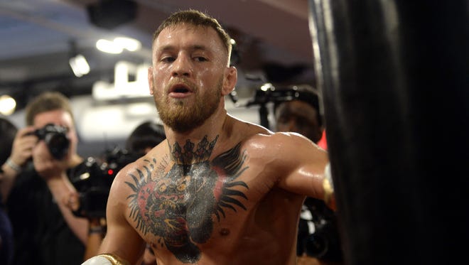 Conor McGregor hits a heavy bag during a media workout in preparation for his fight against Floyd Mayweather, Jr. at UFC Performance Institute.