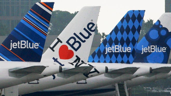 JetBlue planes, each with distinctive tail art, are seen Oct. 25,2011, at the JetBlue terminal at Long Beach Airport in Long Beach, Calif.