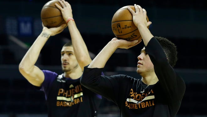 Phoenix Suns' Devin Booker and Alex Len shoot baskets during practice the day before a game against the Dallas Mavericks at Mexico City Arena on Wednesday, Jan. 11, 2017.