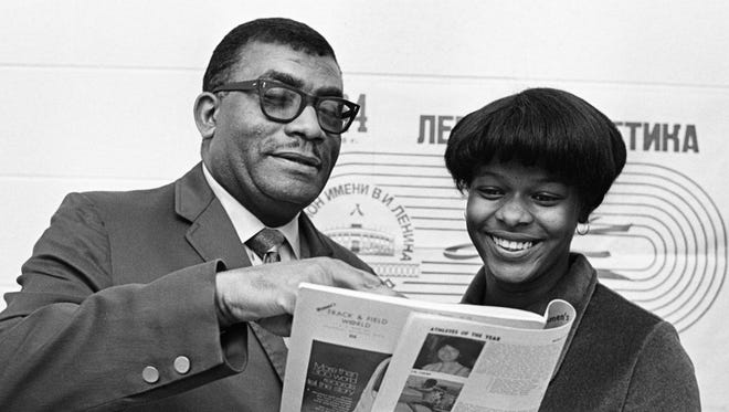 Tennessee State woman's track coach Ed Temple, left, and his brilliant sprinter Iris Davis, read the story of her selection as the Female Athlete of the Year in North America in Women's Track and Field World News Feb. 24, 1971.