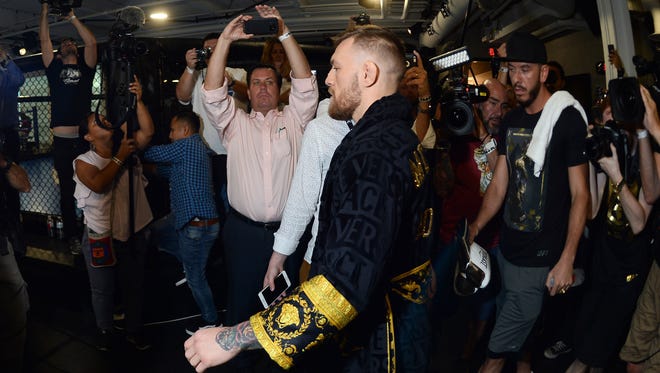 Conor McGregor enters the workout area during a media workout in preparation for his fight against Floyd Mayweather at UFC Performance Institute.