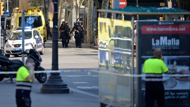 Armed policemen arrive in a cordoned off area in Barcelona on Aug. 17, 2017.