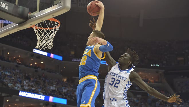 UCLA forward T.J. Leaf dunks against Kentucky forward Wenyen Gabriel during the first half of their game in the Sweet 16 of the NCAA tournament at FedExForum in Memphis.