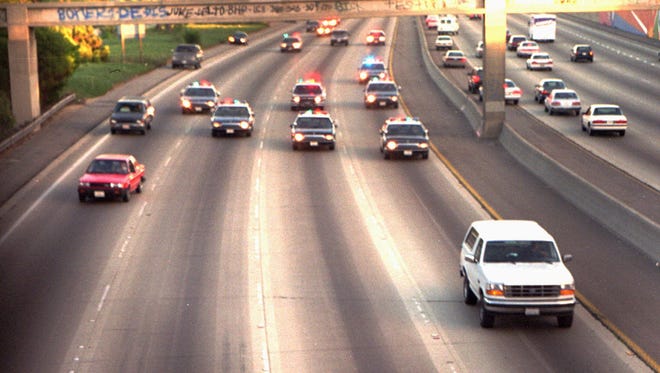 A white Ford Bronco, driven by Al Cowlings and carrying O.J. Simpson, is trailed by police cars as it travels on a southern California freeway on June 17, 1994.