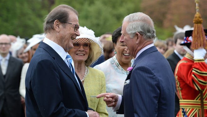Prince Charles, Prince of Wales meets Sir Roger Moore in London May 17, 2016.