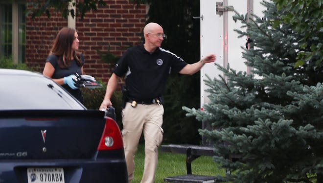 FBI agents carry a computer and other items taken from the Zionsville home of Subway spokesperson Jared Fogle to an evidence truck parked in Fogle's driveway in the 4500 block of Woods Edge Drive on Tuesday morning, July 7, 2015 as the FBI and Indiana State Police conduct a raid during a criminal investigation. Multiple items, including computer devices and media storage disks, were taken from the home to the truck for inspection.