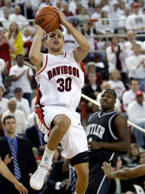2009: Davidson's Stephen Curry shoots as Butler's Shelvin Mack defends during the first half of an NCAA college basketball game.