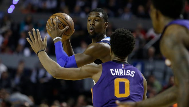 Dallas Mavericks Harrison Barnes looks to pass the ball as Phoenix Suns Marquese Chriss defends during the first half of their regular-season NBA basketball game in Mexico City, Thursday, Jan. 12, 2017.