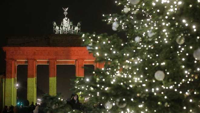 The Brandenburg Gate is illuminated in the colors of the German flag in Berlin, Germany on Dec. 20, 2016, the day after a truck ran into a crowded Christmas market killing 12 and injuring almost 50 others.