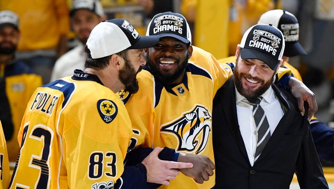Nashville Predators players P.K. Subban (center), Vernon Fiddler (left) and Mike Fisher (right) celebrate after a 6-3 win against the Anaheim Ducks that clinched a Stanley Cup Final berth.