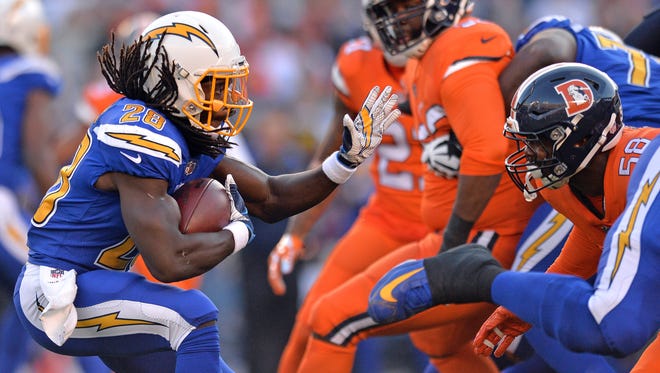 San Diego Chargers running back Melvin Gordon (28) is defended by Denver Broncos outside linebacker Von Miller (58) on a first quarter run at Qualcomm Stadium.