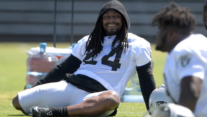 Raiders running back Marshawn Lynch stretches before practice in Napa, Calif.