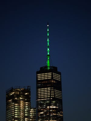 As directed by New York Governor Andrew Cuomo in response to President Donald Trump's decision to pull the United States out of the Paris Climate Accord, One World Trade Center is illuminated with green light,  June 1, 2017 in New York City. Trump pledged on the campaign trail to withdraw from the accord, which former President Barack Obama and the leaders of 194 other countries signed in 2015. The agreement is intended to encourage the reduction of greenhouse gas emissions in an effort to limit global warming to a manageable level.