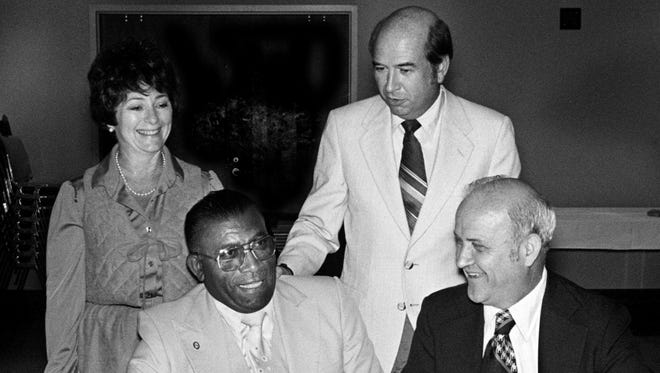 On his birthday, Ed Temple, seated left, and Dessel Aderholt, of Broadman Press, sign a contract for the publication of a book on the life of the famed coach of Tennessee State Tigerbelles Sept. 20, 1979. Looking on are co-author B'Lou Carter, back left, and Chancellor Roy Nicks of the State Board of Regents.