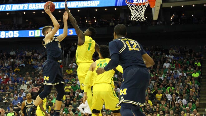 Michigan Wolverines forward Moritz Wagner (13) shoots as Oregon Ducks forward Jordan Bell (1) defends during the first half in the semifinals of the midwest Regional of the 2017 NCAA tournament at Sprint Center.