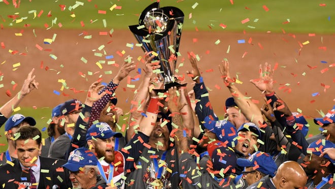 United States players hold up the championship trophy after defeating Puerto Rico in the final of the World Baseball Classic at Dodger Stadium.