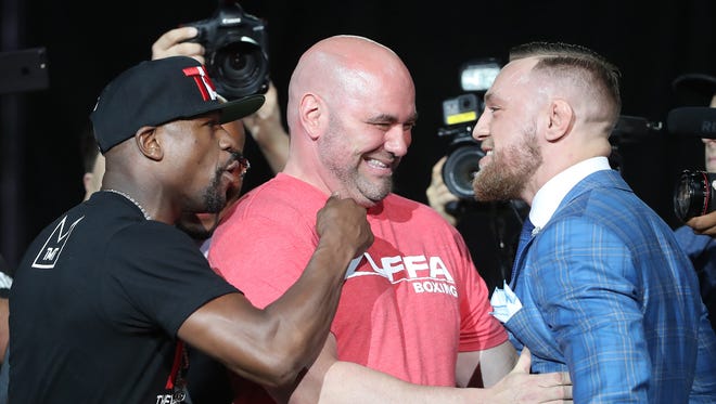 UFC President Dana White separates Floyd Mayweather and Conor McGregor as they stare each other down during a world tour press conference to promote the upcoming Mayweather vs McGregor boxing match.