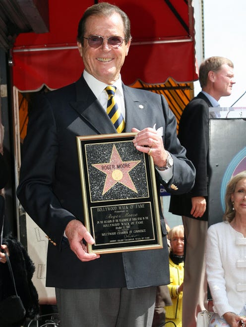 Roger Moore poses after being honored with a Star on the Hollywood Walk of Fame, Oct ,11, 2007, in Hollywood, Calif.
