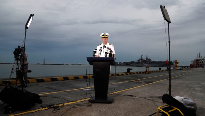 Commander of the U.S. Pacific Fleet, Scott Swift answers questions during a press conference with the USS John S. McCain and USS America docked in the background at Singapore's Changi naval base  Aug. 22, 2017 in Singapore.