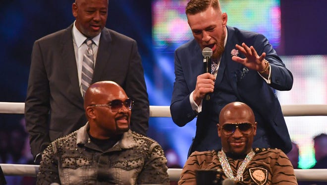 Conor McGregor reacts to Floyd Mayweather during a world tour press conference to promote the upcoming Mayweather vs McGregor boxing fight at SSE Arena.