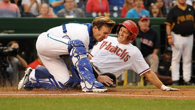 Arizona Republican Sen. Jeff Flake slides into home with Connecticut Democratic Sen. Chris Murphy as catcher during the annual congressional baseball game at Nationals Park on June 23, 2016.