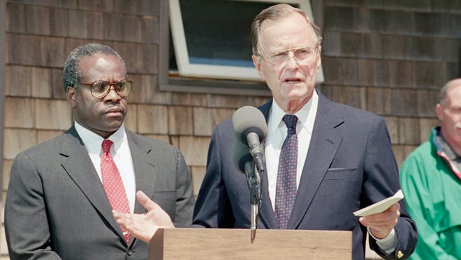 President George H.W. Bush introduces Clarence Thomas as his nominee to replace retiring Justice Thurgood Marshall during a press conference on July 1, 1991, at his summer home in Kennebunkport, Maine