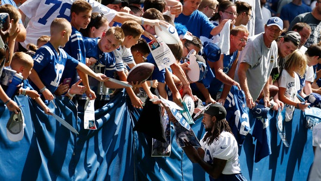 Indianapolis Colts wide receiver T.Y. Hilton (13) signs autographs after the completion of practice during Indianapolis Colts Training Camp at Lucas Oil Stadium.