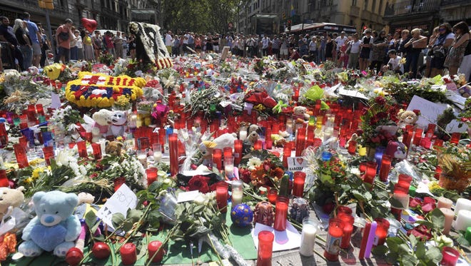 People display flowers, candles, balloons and many objects to pay tribute to the victims of the Barcelona and Cambrils attacks on the Rambla boulevard in Barcelona on Aug. 21, 2017, four days after the Barcelona and Cambrils attacks that killed 15 people.