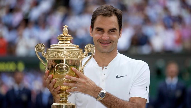 Roger Federer poses with the trophy after winning Wimbledon.