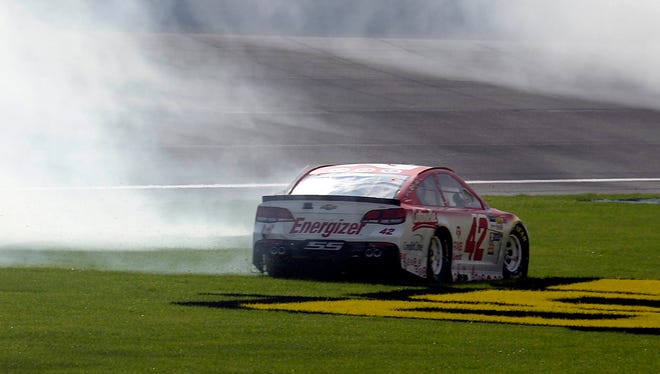 Kyle Larson takes a spin in the grass after winning the Auto Club 400 Sunday.
