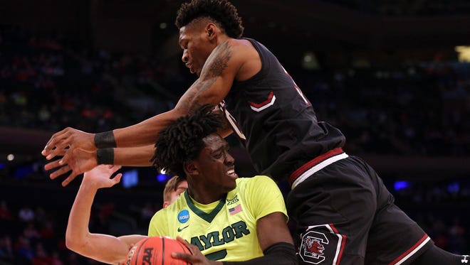 South Carolina forward Chris Silva, right, jumps onto Baylor forward Johnathan Motley during the first half of their game in the Sweet 16 of the NCAA tournament at Madison Square Garden in New York.