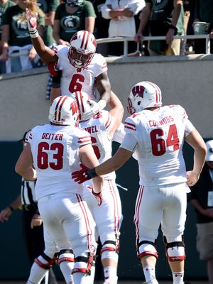 Corey Clement celebrates with Wisconsin Badgers teammates.
