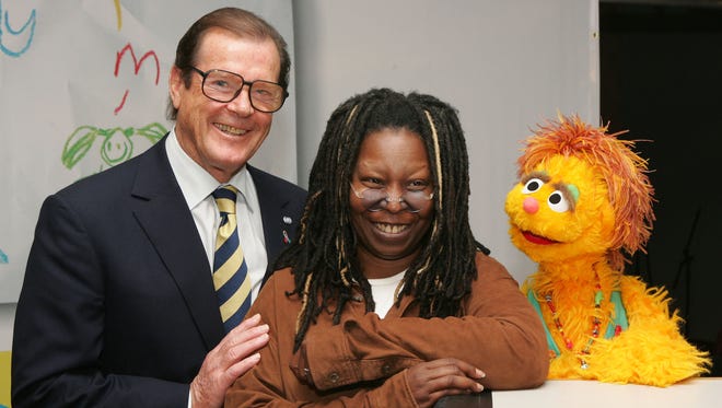 Actors Sir Roger Moore, Whoopi Goldberg and Kami the HIV positive muppet announce a UNICEF and Clear Channel ad campaign for the impact of aids on children on Oct. 27, 2005 in New York City.