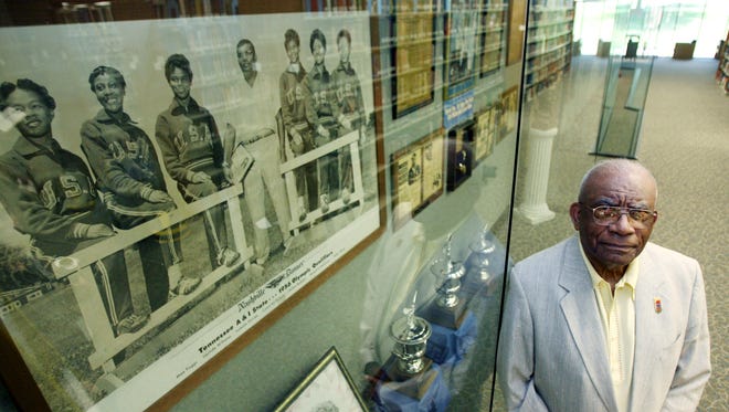 Ed Temple is posing by one of the Tigerbelles exhibit at the Tennessee State University library May 17, 2007. He was the coach at TSU for 44 years and his athletes won a combined 23 Olympic medals, including 13 gold.