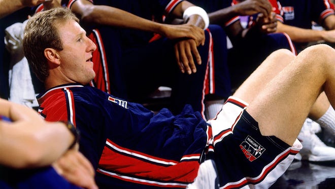 Larry Bird of the United States Men's Basketball Team watches while laying down during a game at the 1992 Olympics in Barcelona, Spain.