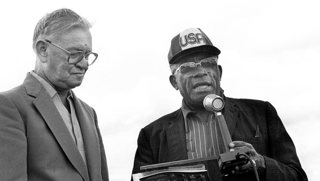Tennessee State track coach Ed Temple, right, presents F.M. Williams, sportswriter for The Tennessean, with a plaque dedicating the Tigerbelle Relays to him April 14, 1984, who provided the impetus for the building of the track on which the meet is run.